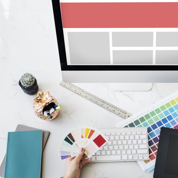 Designer desk with monitor and color swatches